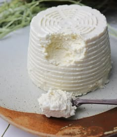 a cake with white frosting sitting on top of a plate