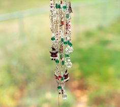 a wind chime hanging from the side of a window with lots of beads on it