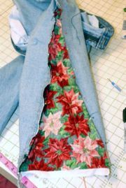 a piece of fabric is being sewn on to a jean jacket with floral print