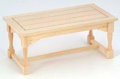 a small wooden table on a white background