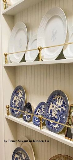 blue and white plates on shelves in a room