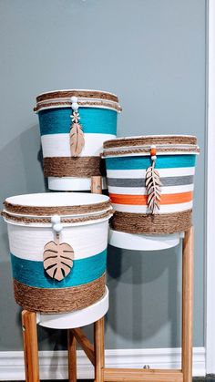 three buckets sitting on top of a wooden stand