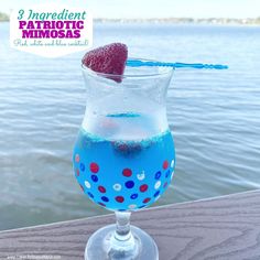 a blue liquid in a glass with a strawberry on top and the caption 3 ingredient patriotic mimos