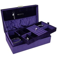 an open purple velvet jewelry box with two necklaces and bracelets in the inside