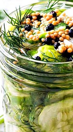 a mason jar filled with pickled vegetables and garnishes