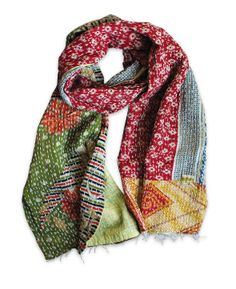 a multicolored scarf with fringes and flowers on the bottom, in various colors