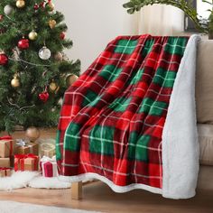 a christmas tree and presents under a blanket