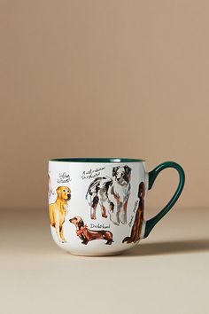 a cup with dogs on it sitting on a table