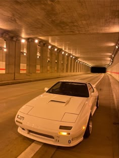 a white sports car parked in a tunnel