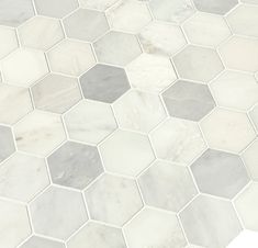 a white and grey hexagonal tile pattern on the floor, with one corner missing