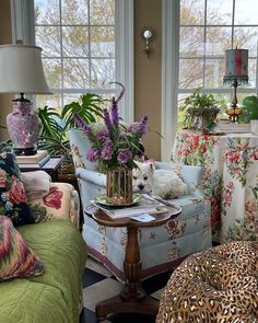 a living room filled with lots of furniture and flowers