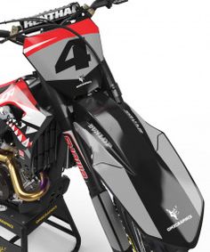 a red and black snowmobile with the number four on it's front wheel