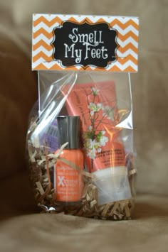 an orange and white gift bag filled with personal care items