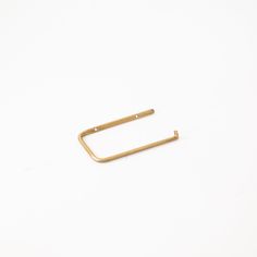 a pair of gold metal clips on a white background with space for text or image