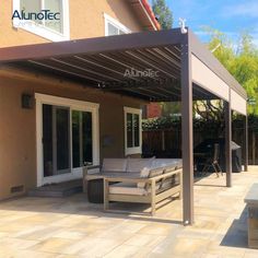 an outdoor patio with furniture under a pergolated roof