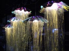 some very pretty lights in the dark with water flowing down them and hanging from it's sides