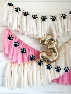 a dog themed birthday party with balloons and streamers for the number 3 on it