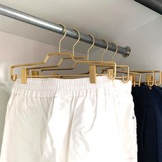 some pants hanging on a rack in a closet