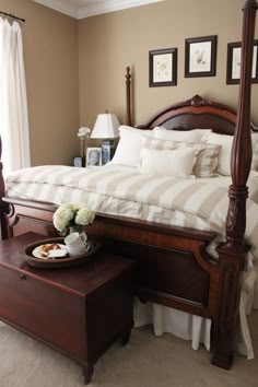 a large bed sitting next to a window in a bedroom on top of a carpeted floor