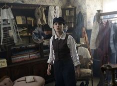 a woman in an old fashioned clothing store