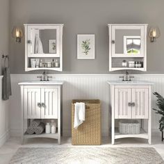 a white bathroom with two sinks and mirrors