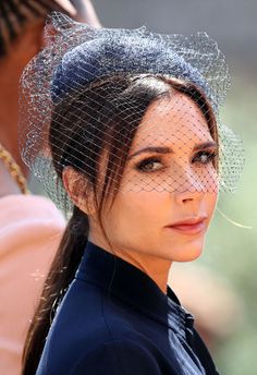 a woman wearing a birdcage veil on her head