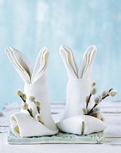 two white ceramic rabbits sitting next to each other