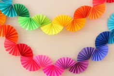 multicolored paper fans arranged in the shape of a heart