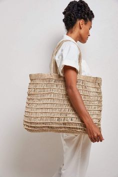 a woman carrying a woven straw bag