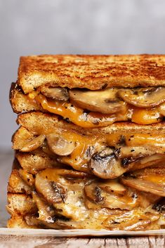 a grilled cheese and mushroom sandwich stacked on top of each other