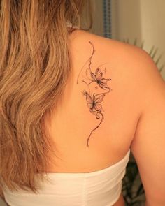 a woman with a tattoo on her back