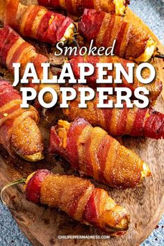 bacon wrapped jalapeno poppers on a cutting board with the words smoked jalapeno poppers