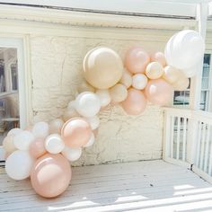 some balloons are hanging from the side of a house