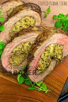 sliced flank steak on a cutting board with herbs