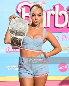 the model poses with her trophy at the launch event for barbie's new toy line