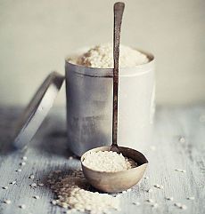 a measuring cup filled with white powder next to a spoon