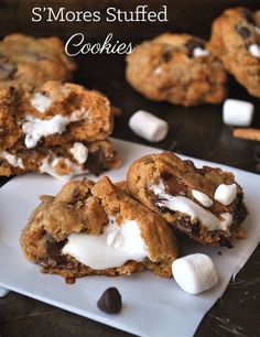 two cookies with marshmallows and chocolate chips on top are sitting on a white plate