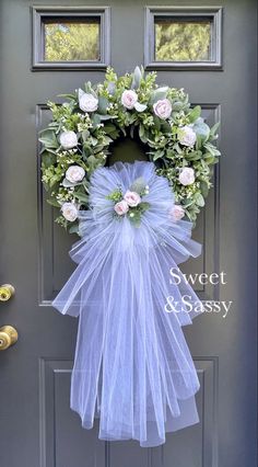 a wreath on the front door with flowers