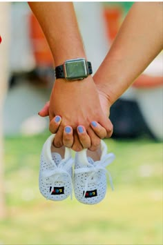 two people holding hands while wearing white shoes