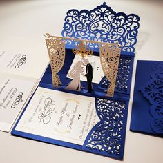 a blue and white wedding card with a cutout bride and groom on the front