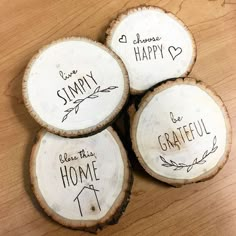 four wood slices with the words happy, home, and grateful written on them