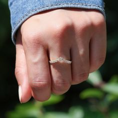 a woman's hand with a diamond ring on it