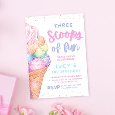 an ice cream themed birthday party with pink flowers and decorations on the table, including two scoops of ice cream