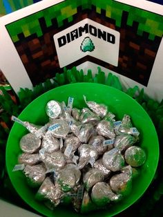 a green bowl filled with silver foil next to a sign that says diamond on it