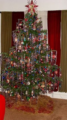 a decorated christmas tree in the corner of a room