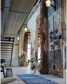 an old building with exposed brick walls and stone staircase leading up to the second floor