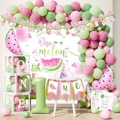 a watermelon themed birthday party with balloons and decorations