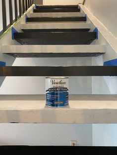 a can of paint sitting on top of some stairs