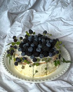 a cake with blueberries and blackberries on top