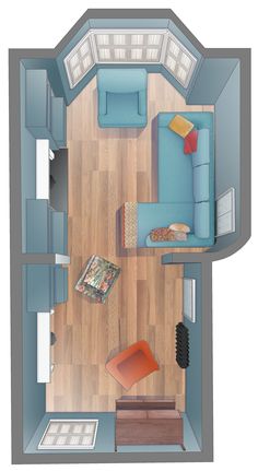 an overhead view of a small living room with blue couches and wood flooring